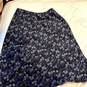 Mid length skirt with an elastic waist size M gray and black floral